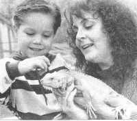 Wally on the job helping a child learn about iguanas.